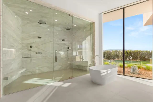 Spa-inspired primary bathroom remodel with freestanding tub and stone tile in Las Vegas